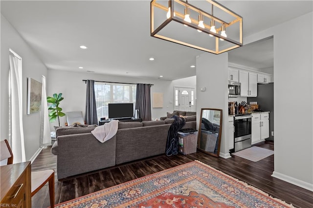 living room with recessed lighting, baseboards, and dark wood-type flooring