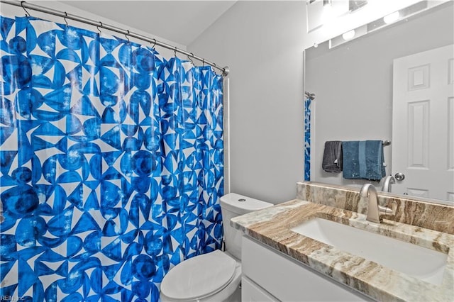 bathroom featuring toilet, curtained shower, and vanity