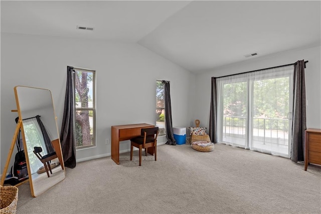 interior space featuring a wealth of natural light, carpet, lofted ceiling, and visible vents