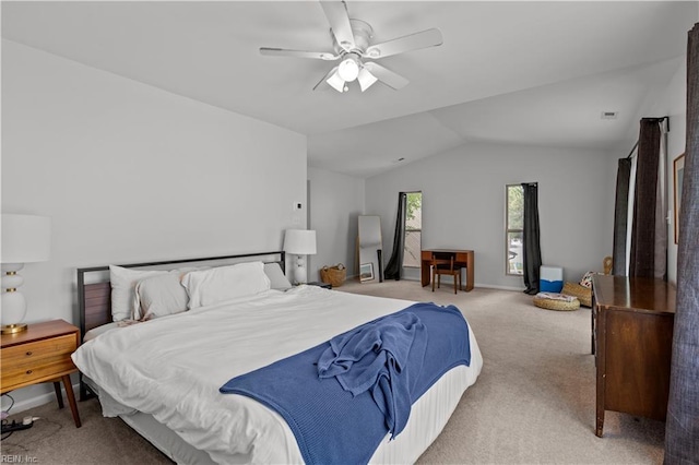 carpeted bedroom with a ceiling fan and vaulted ceiling