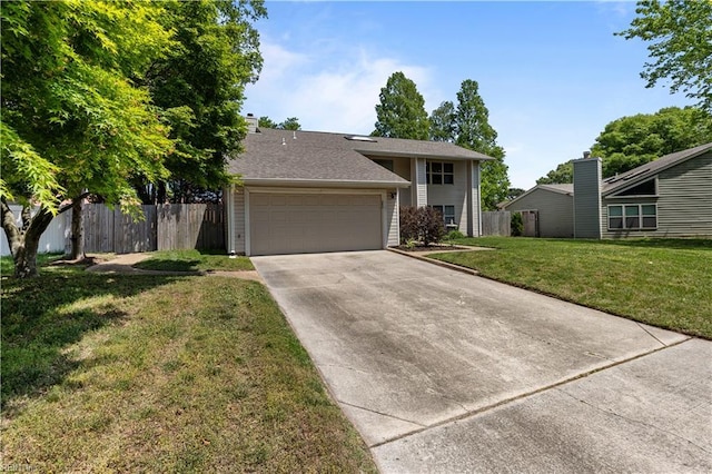 split level home featuring driveway, a chimney, a front yard, a garage, and fence