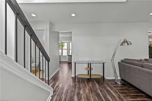 interior space featuring stairway, baseboards, recessed lighting, and dark wood-style floors