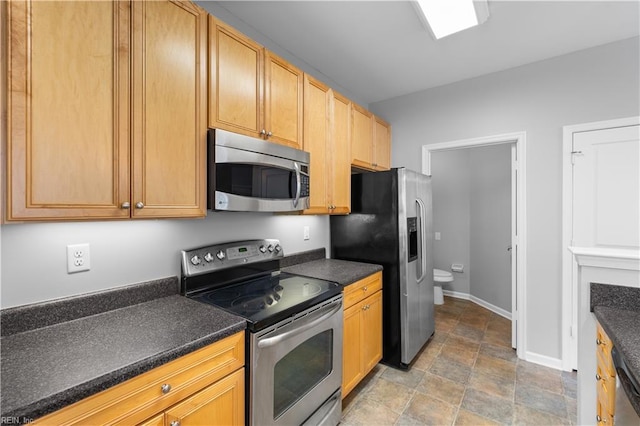 5324 Tamworth Pl, Virginia Beach, VA 23455 - kitchen featuring appliances with stainless steel finishes, dark countertops, stone finish floors, and baseboards