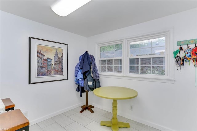 interior space featuring baseboards and tile patterned flooring