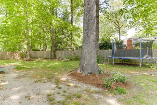 view of yard featuring a fenced backyard and a trampoline