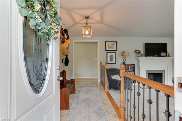 foyer entrance with light tile patterned floors and a fireplace