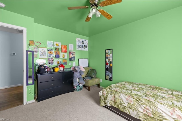 carpeted bedroom with baseboards and ceiling fan