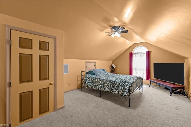 carpeted bedroom featuring visible vents, a ceiling fan, and lofted ceiling