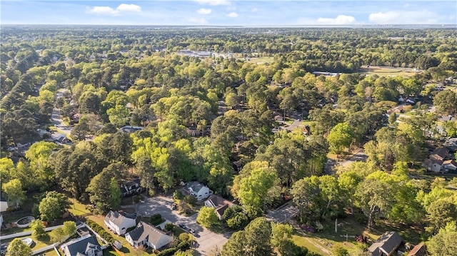birds eye view of property featuring a wooded view
