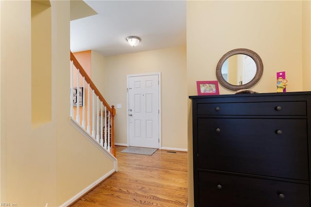 13095 Lighthouse Ln, Carrollton, VA 23314 - entryway with light wood-type flooring, stairs, and baseboards