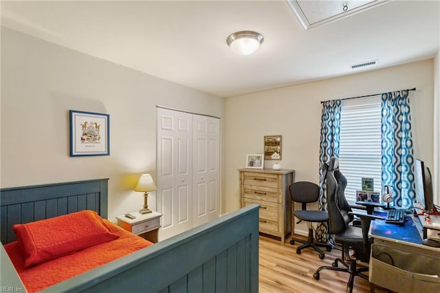 13095 Lighthouse Ln, Carrollton, VA 23314 - bedroom featuring light wood-type flooring, a closet, a desk, and attic access