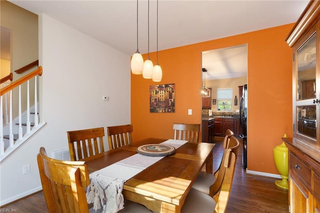 13095 Lighthouse Ln, Carrollton, VA 23314 - dining room with dark wood-style flooring, stairway, and baseboards