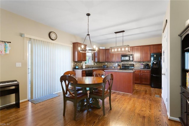 13095 Lighthouse Ln, Carrollton, VA 23314 - dining area featuring wood finished floors and a chandelier