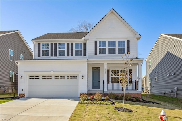 traditional-style home with covered porch, driveway, a front yard, and a garage