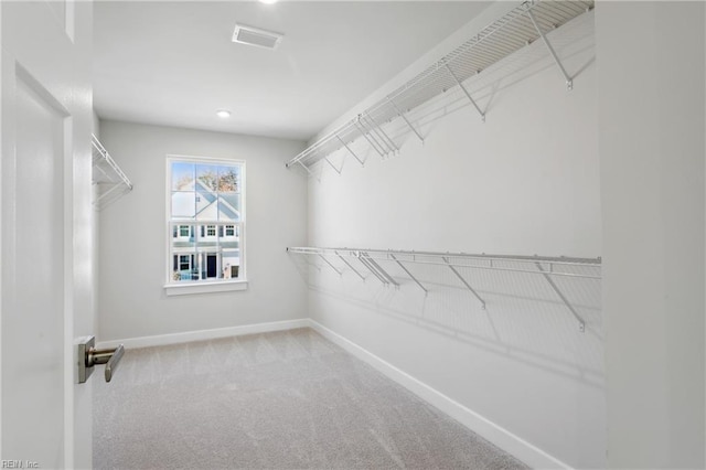 spacious closet with visible vents and carpet flooring