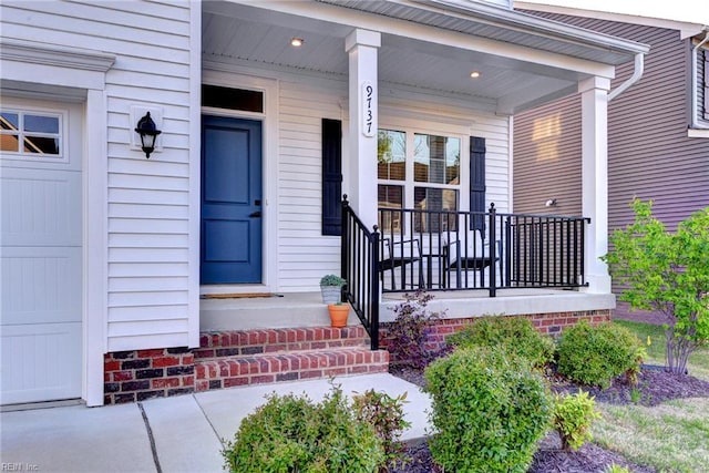 view of exterior entry with a porch