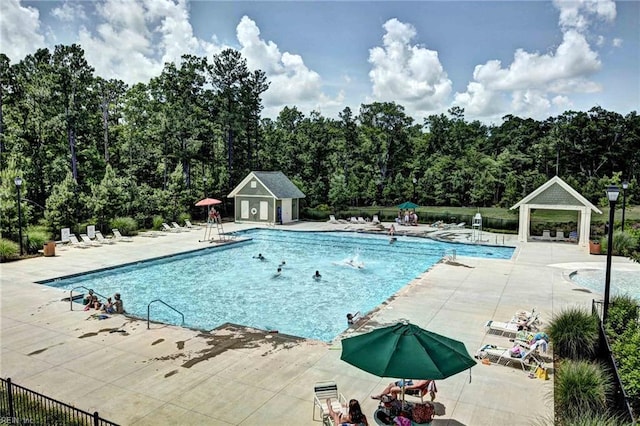 pool featuring a patio area and fence