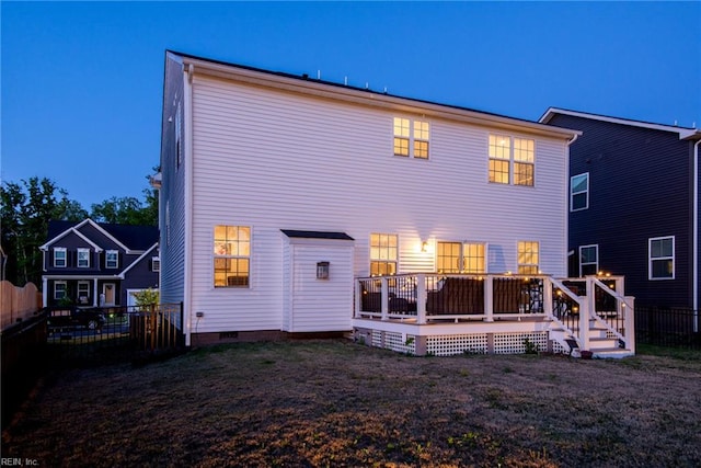 rear view of property featuring a yard, crawl space, a fenced backyard, and a deck