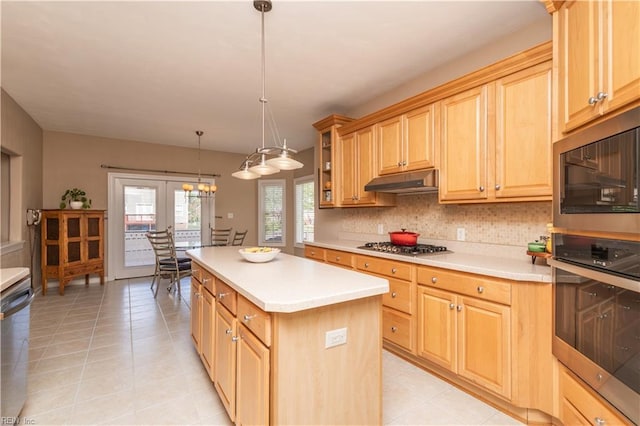 kitchen with light tile patterned flooring, a center island, light countertops, under cabinet range hood, and stainless steel appliances