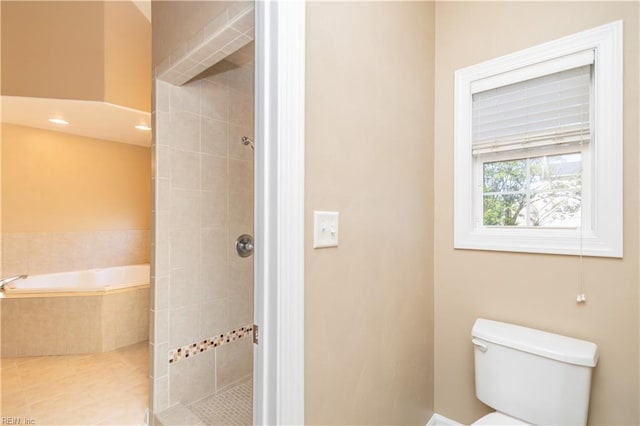 bathroom with a garden tub, tile patterned floors, toilet, and tiled shower