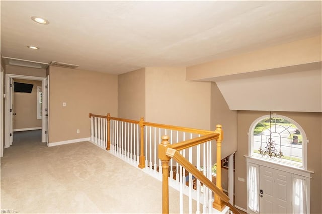 hallway featuring carpet, recessed lighting, baseboards, an upstairs landing, and visible vents