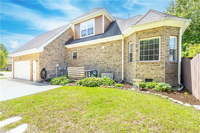 view of property exterior featuring central air condition unit, brick siding, a garage, concrete driveway, and a lawn