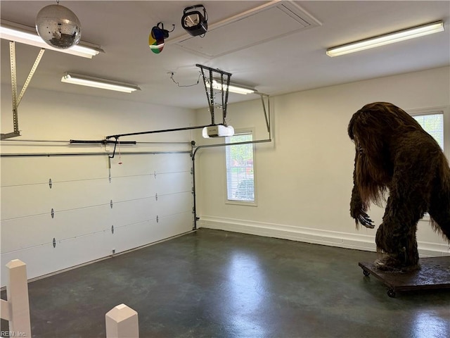 garage with baseboards and a garage door opener