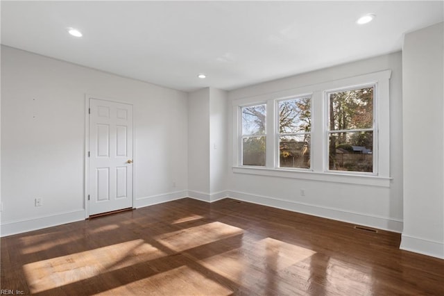 unfurnished room featuring recessed lighting, baseboards, visible vents, and wood finished floors