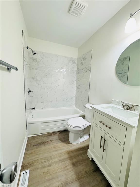 529 Stockton St, Hampton, VA 23669 - full bathroom featuring vanity, shower / bathtub combination, toilet, and wood finished floors