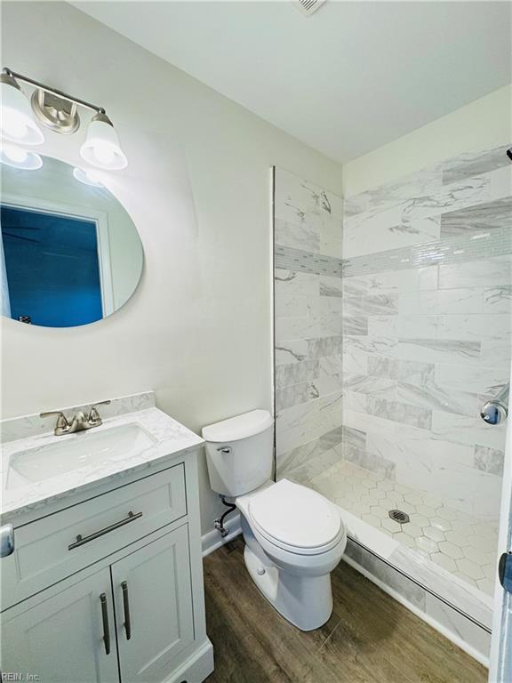 529 Stockton St, Hampton, VA 23669 - full bathroom featuring wood finished floors, a stall shower, vanity, and toilet