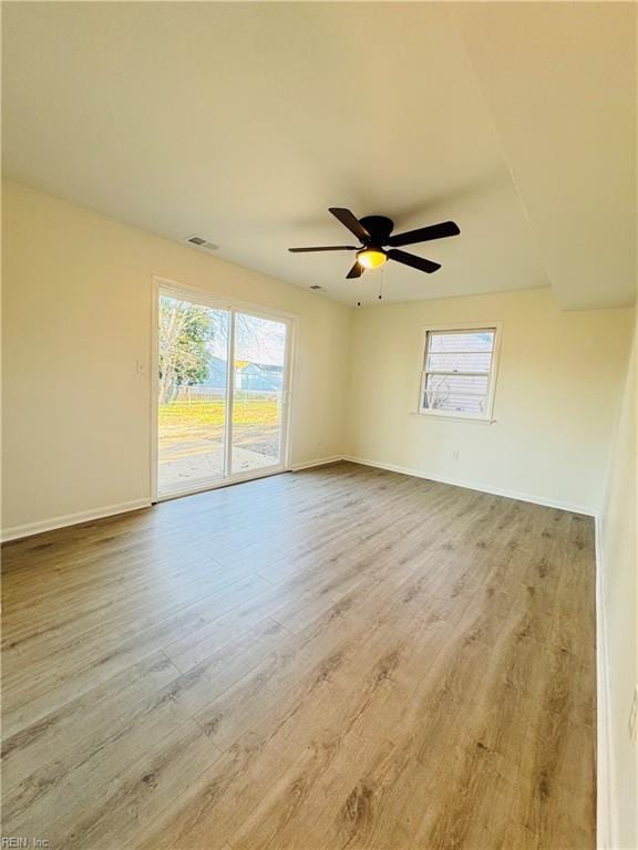 529 Stockton St, Hampton, VA 23669 - empty room with healthy amount of natural light, wood finished floors, a ceiling fan, and baseboards