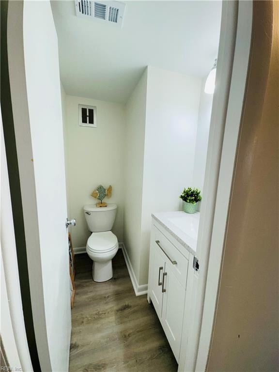 529 Stockton St, Hampton, VA 23669 - bathroom with wood finished floors, vanity, toilet, and baseboards