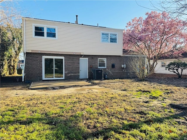 529 Stockton St, Hampton, VA 23669 - back of property featuring brick siding, central AC, and a yard