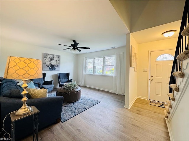 529 Stockton St, Hampton, VA 23669 - living room featuring light wood-style flooring, stairs, ceiling fan, and baseboards