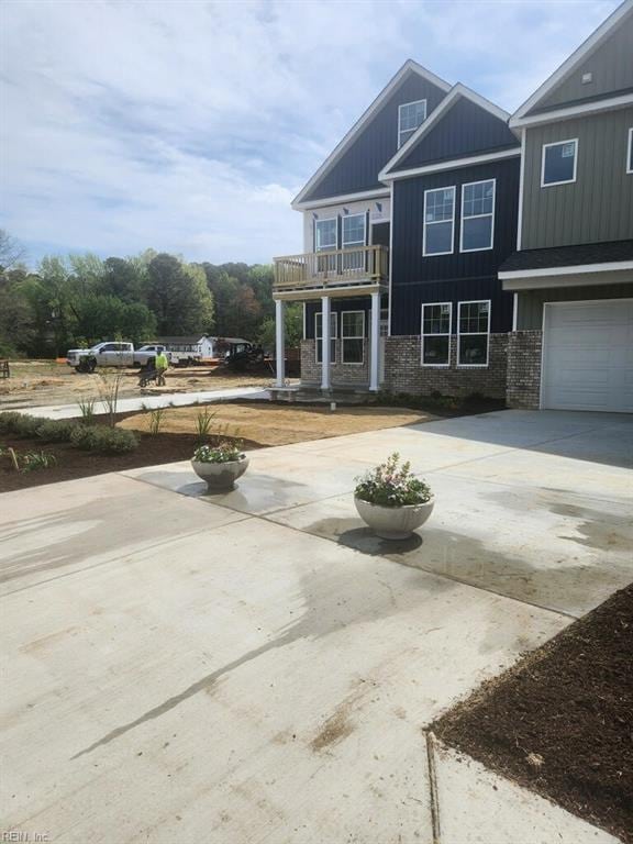 14307 Old Courthouse Way Unit G, Newport News, VA 23602 - view of front of home featuring a balcony, concrete driveway, and an attached garage