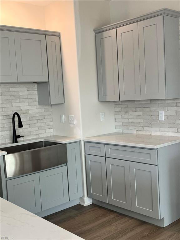 14307 Old Courthouse Way Unit G, Newport News, VA 23602 - kitchen featuring gray cabinetry, a sink, decorative backsplash, and light countertops