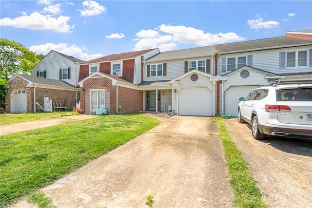 multi unit property with brick siding, a garage, driveway, and a front yard