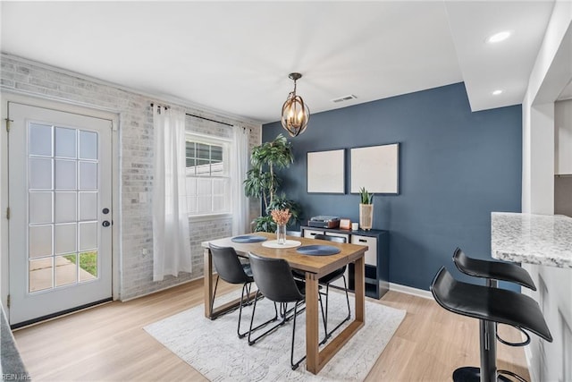 dining area featuring an accent wall, recessed lighting, baseboards, light wood-type flooring, and visible vents