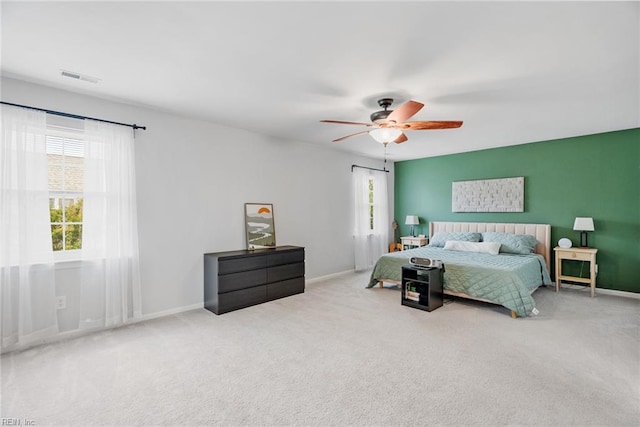 bedroom with carpet flooring, ceiling fan, visible vents, and baseboards
