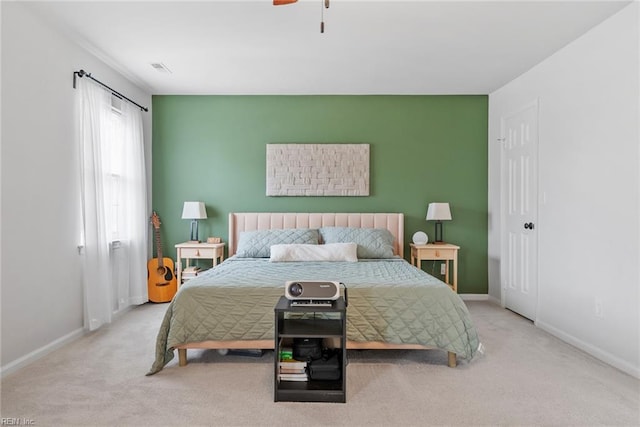 carpeted bedroom with baseboards, visible vents, and ceiling fan