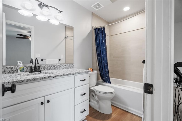 full bath featuring vanity, toilet, wood finished floors, shower / tub combo, and visible vents