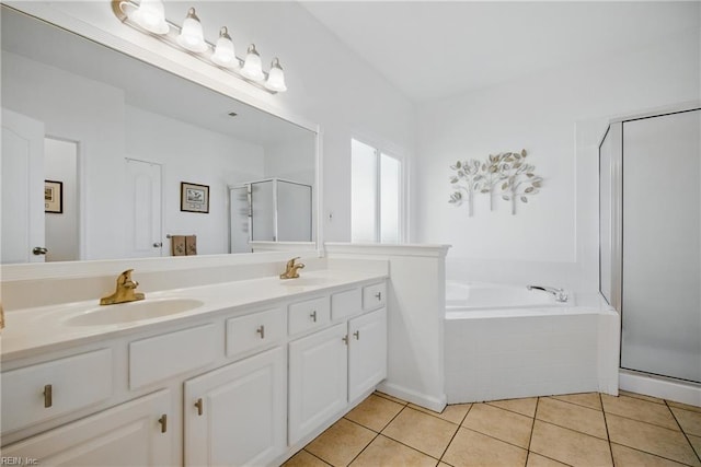 full bathroom featuring a sink, double vanity, tile patterned floors, a shower stall, and a bath