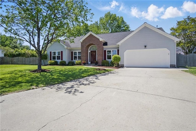 ranch-style house with an attached garage, fence, driveway, and a front yard