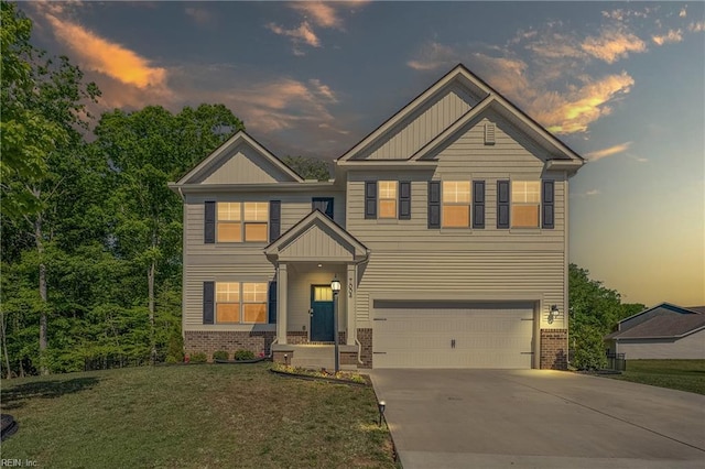 craftsman-style home featuring a garage, a front lawn, brick siding, board and batten siding, and concrete driveway