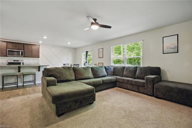 living room featuring recessed lighting, ceiling fan, and light carpet