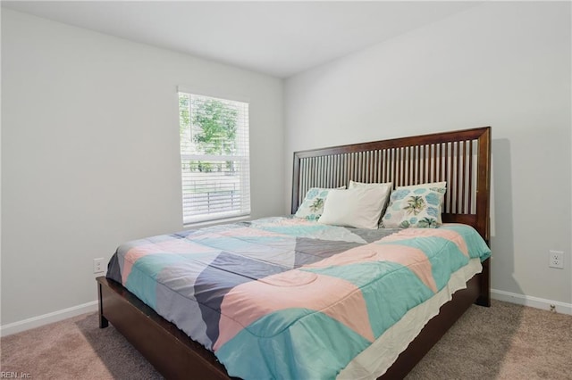 bedroom featuring carpet flooring and baseboards