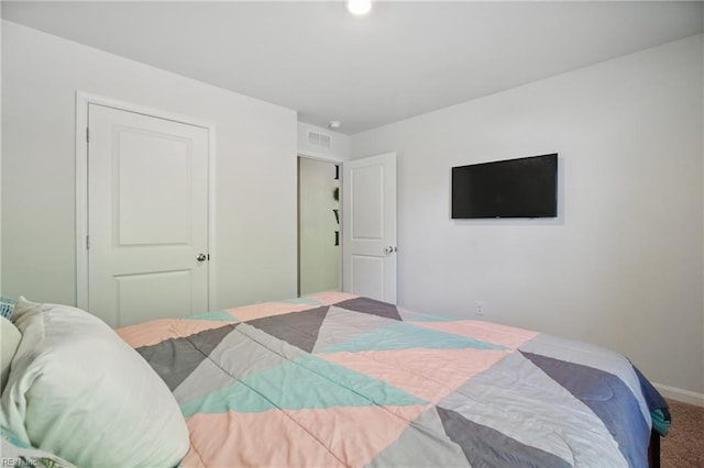 bedroom featuring carpet floors, baseboards, and visible vents
