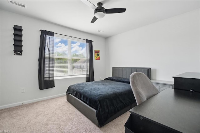 carpeted bedroom with visible vents, baseboards, and ceiling fan