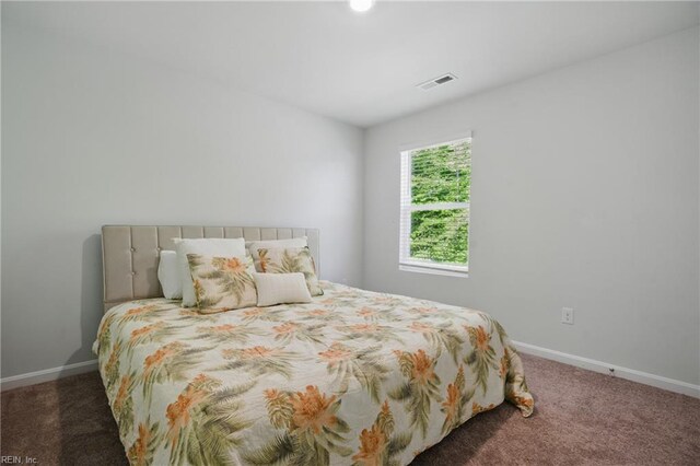 carpeted bedroom with baseboards and visible vents