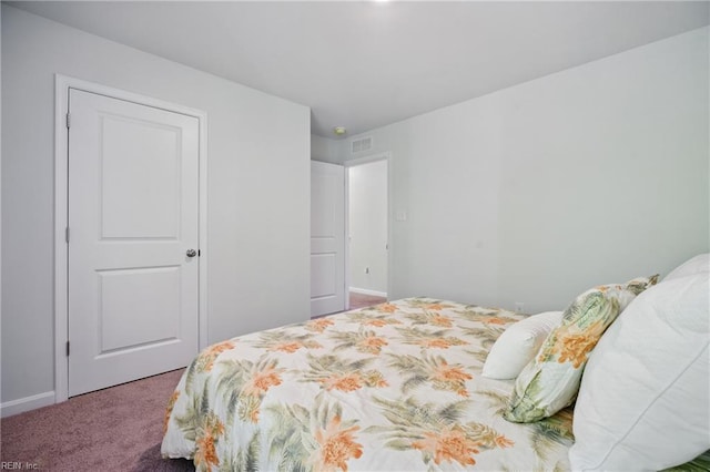 carpeted bedroom featuring visible vents and baseboards